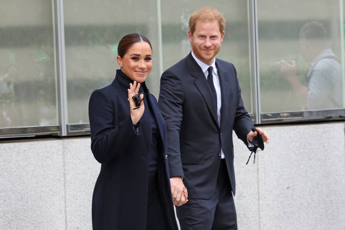 The Duke and Duchess of Sussex smile and wave to the camera