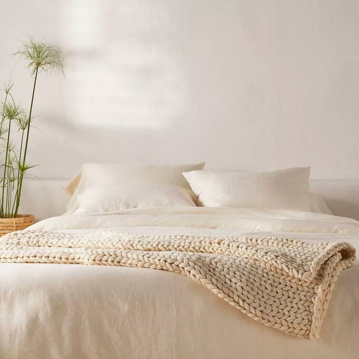 Blanket in color &quot;Natural&quot; shown on a bed