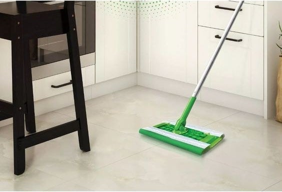 swiffer with a wet cloth cleaning a floor