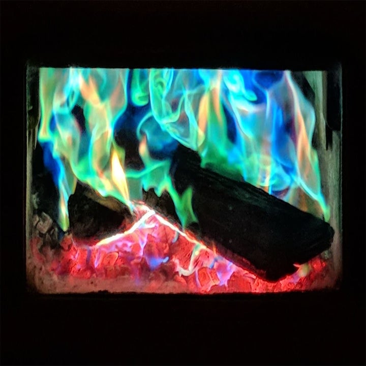 an indoor fireplace with colorful flames