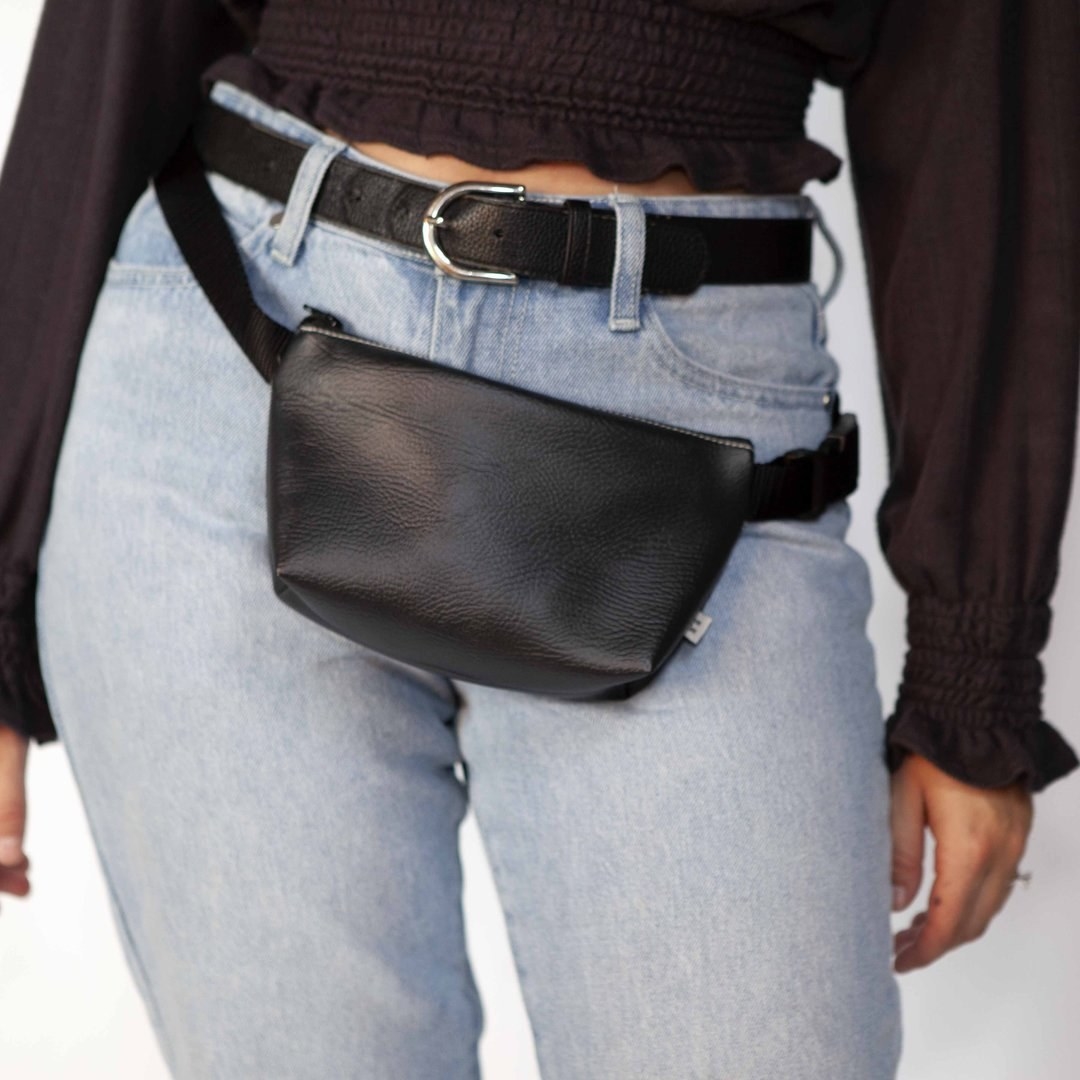 a model wearing a black belt bag