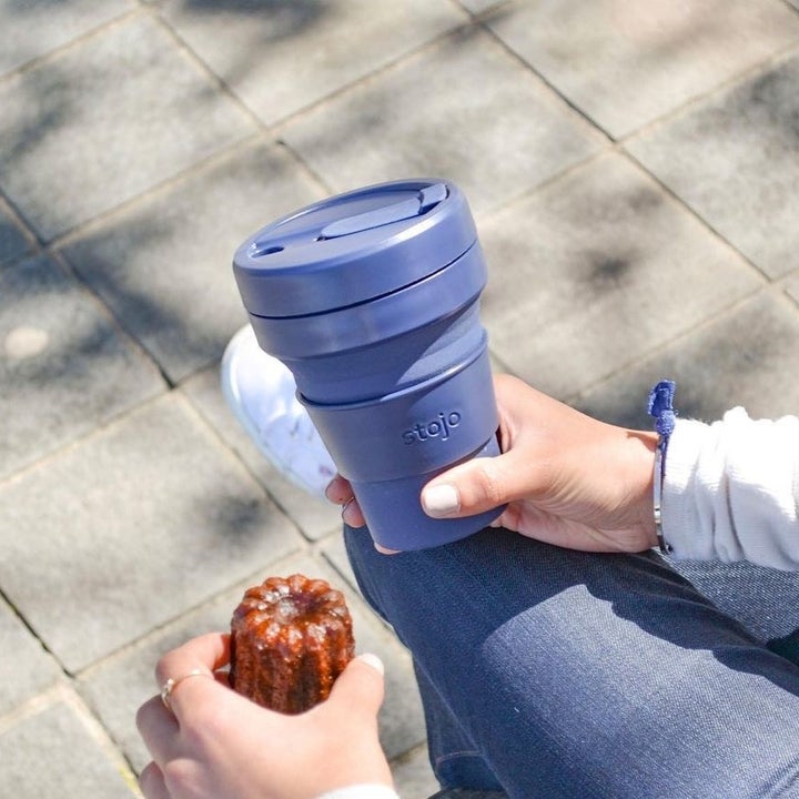 someone holding the collapsible cup when it's popped up to full size