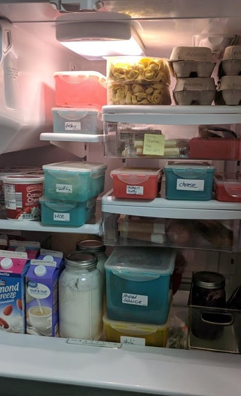A reviewer shows their fridge full of with labeled items