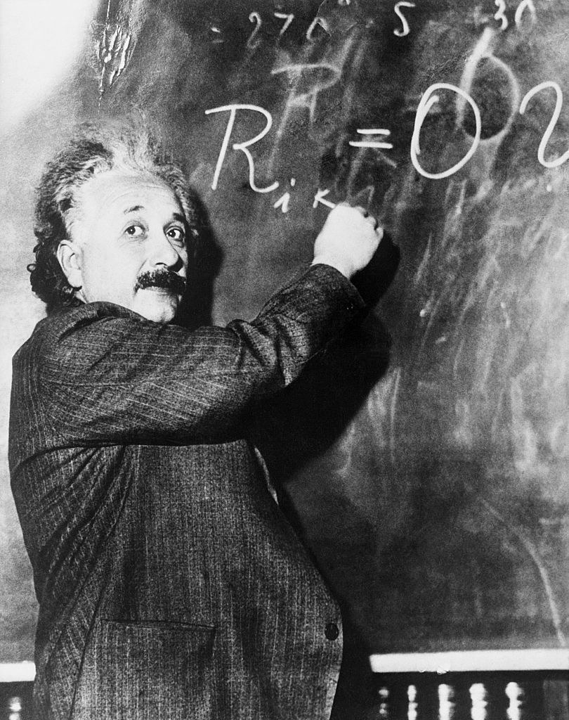 Einstein writing on a chalkboard