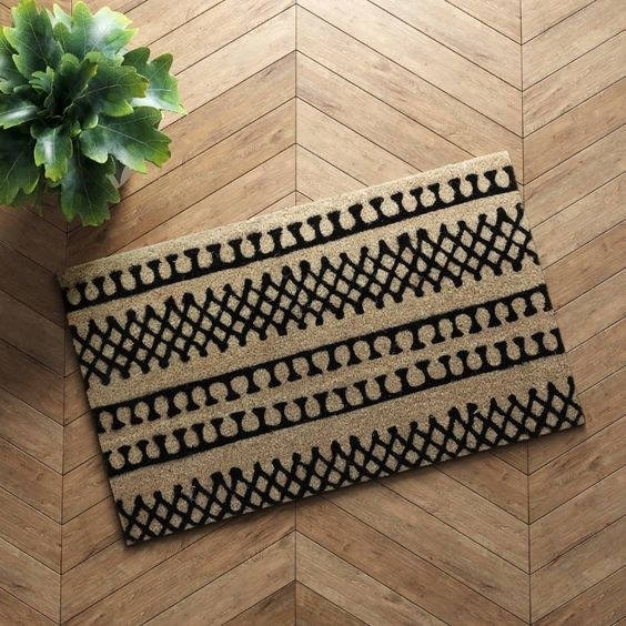 brown doormat with a black linear pettern