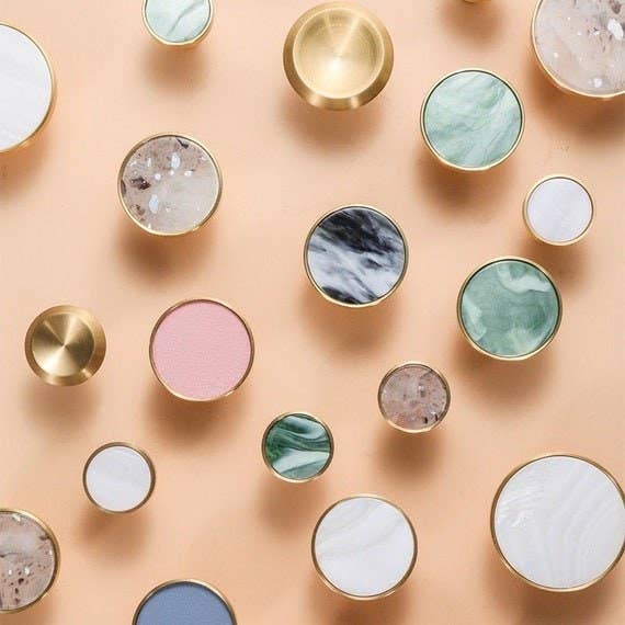 Display of round differently colored and patterned knobs with gold trimming