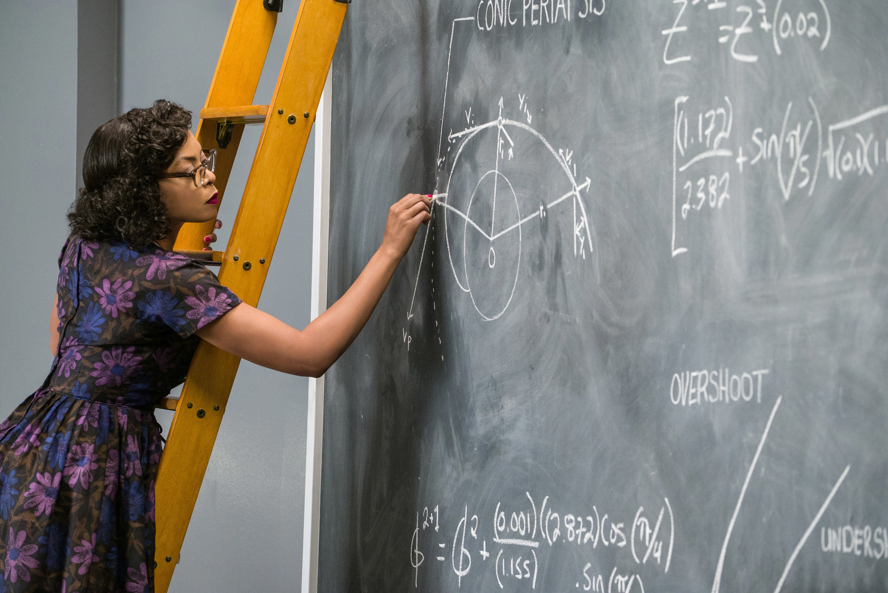 Katherine working out a calculation on a chalkboard