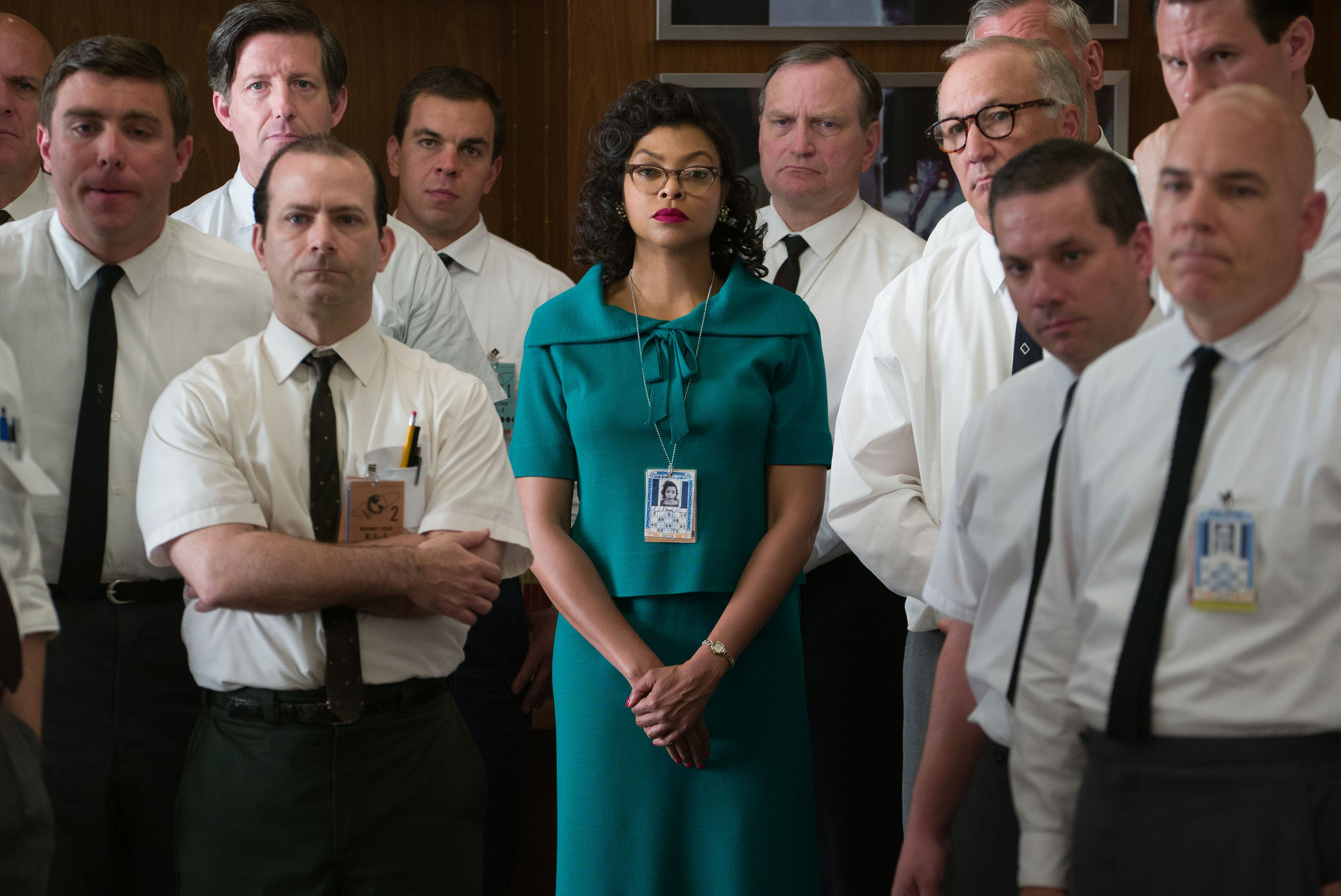 Katherine Johnson, a Black woman, standing amongst a group of white, male colleagues