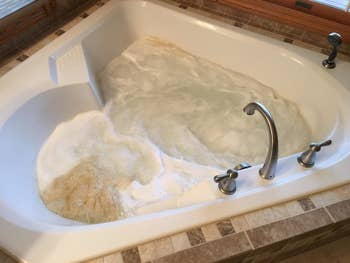 reviewer's foamy tub with brown gunk from the jets