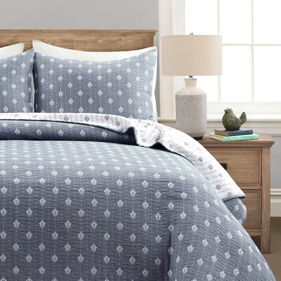 Quilt set shown on a bed in color &quot;Navy/Off-White&quot;