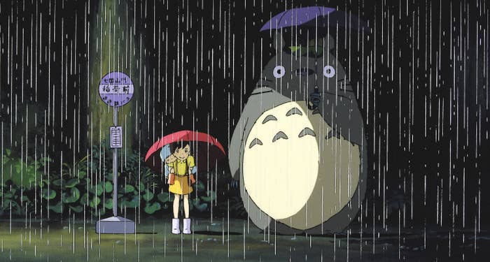 The sisters from &quot;My Neighbor Totoro&quot; standing in the rain with Totoro, holding umbrellas