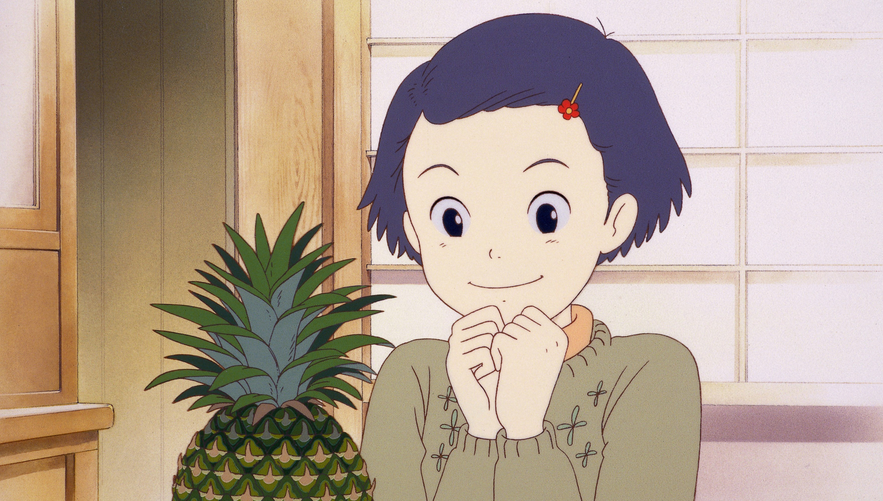 A young Taeko staring happily at a pineapple