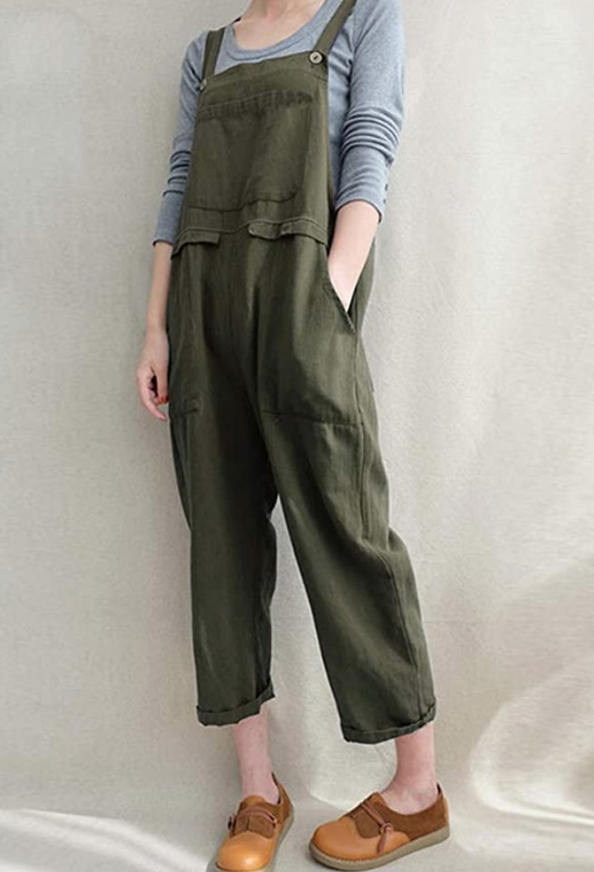A model wearing a pair of army green linen overalls