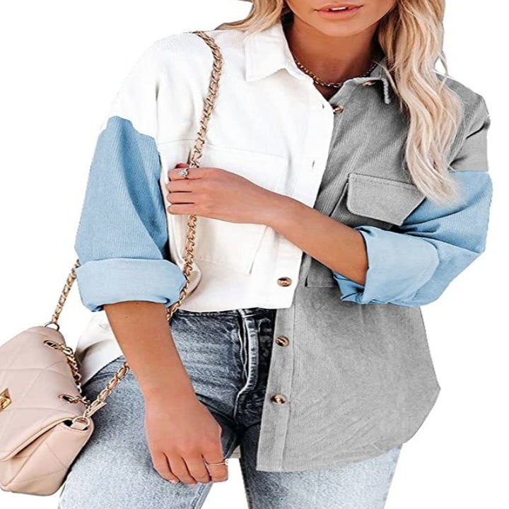 A model wearing the corduroy button down in sky blue/grey/white with pockets