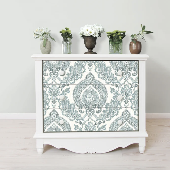 The wallpaper applied to the front of a chest of drawers