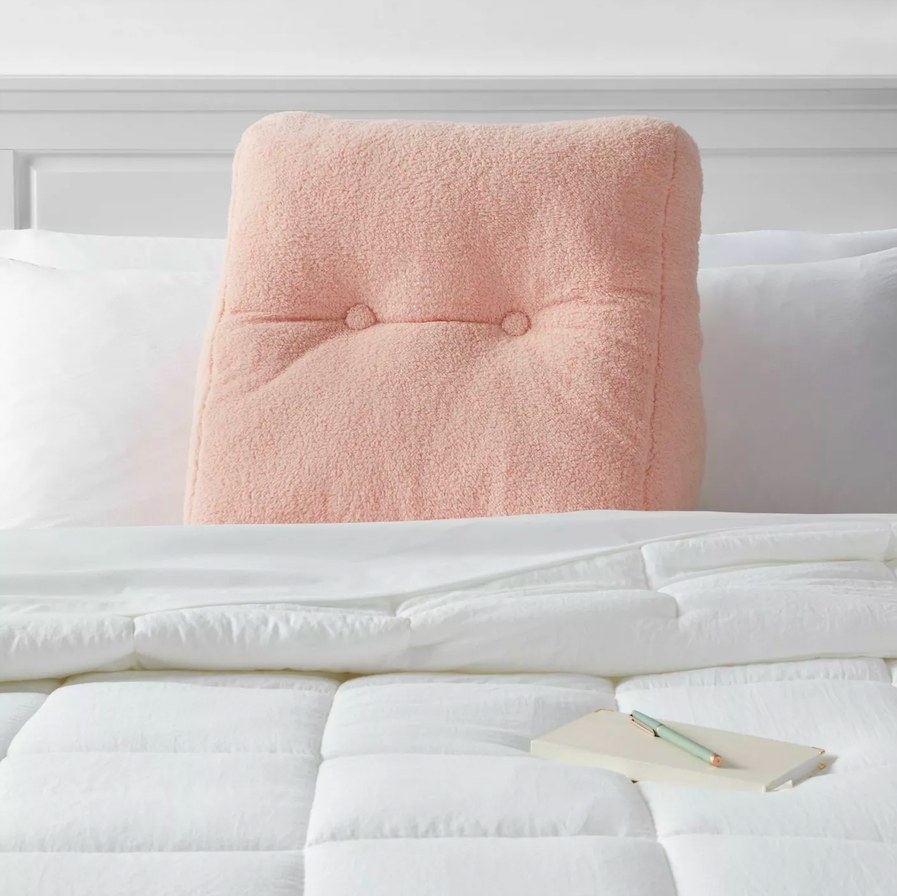 Pillow in color &quot;Blush&quot; shown in a bed