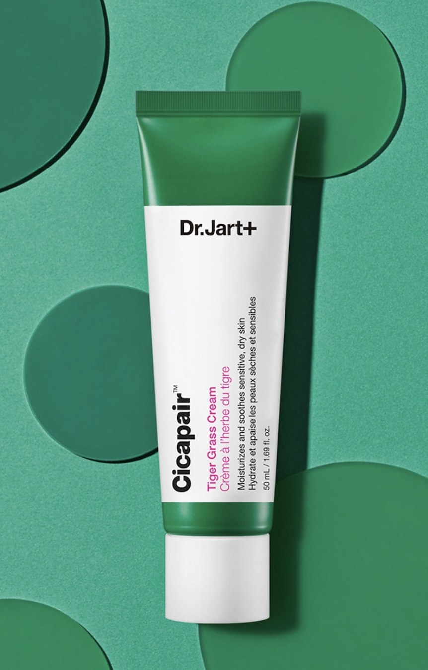 a product shot of the cream against a green background