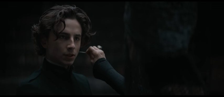 Paul with a needle held to his neck by Mohiam in "Dune"