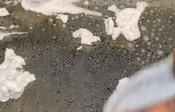 GIF of the cleaner being used to clean an oven door