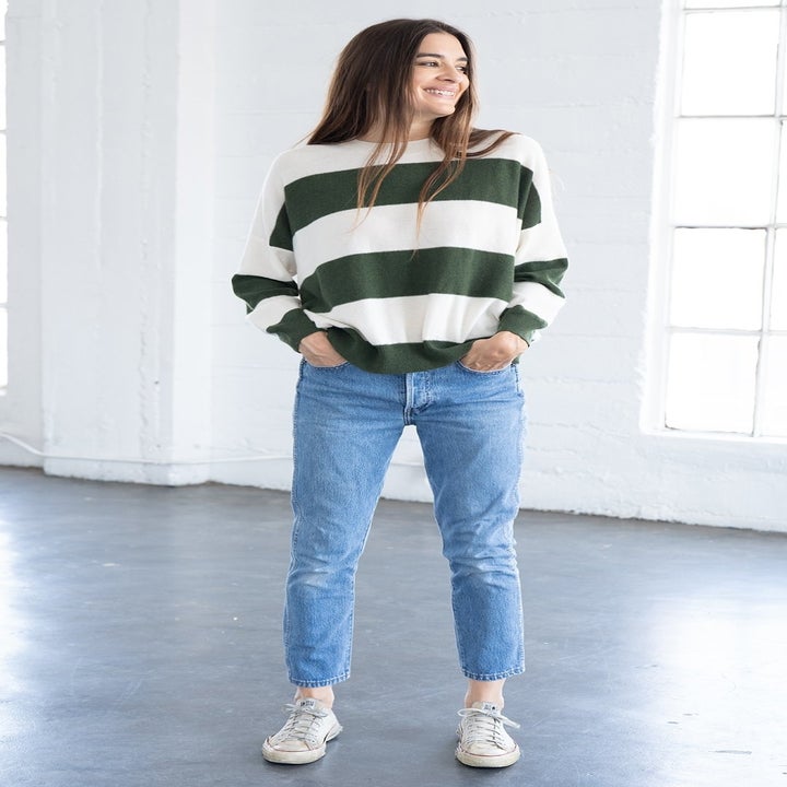 a model wearing the green and white striped sweater
