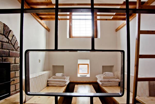 Hostel room in prison cell with barred entry and small window