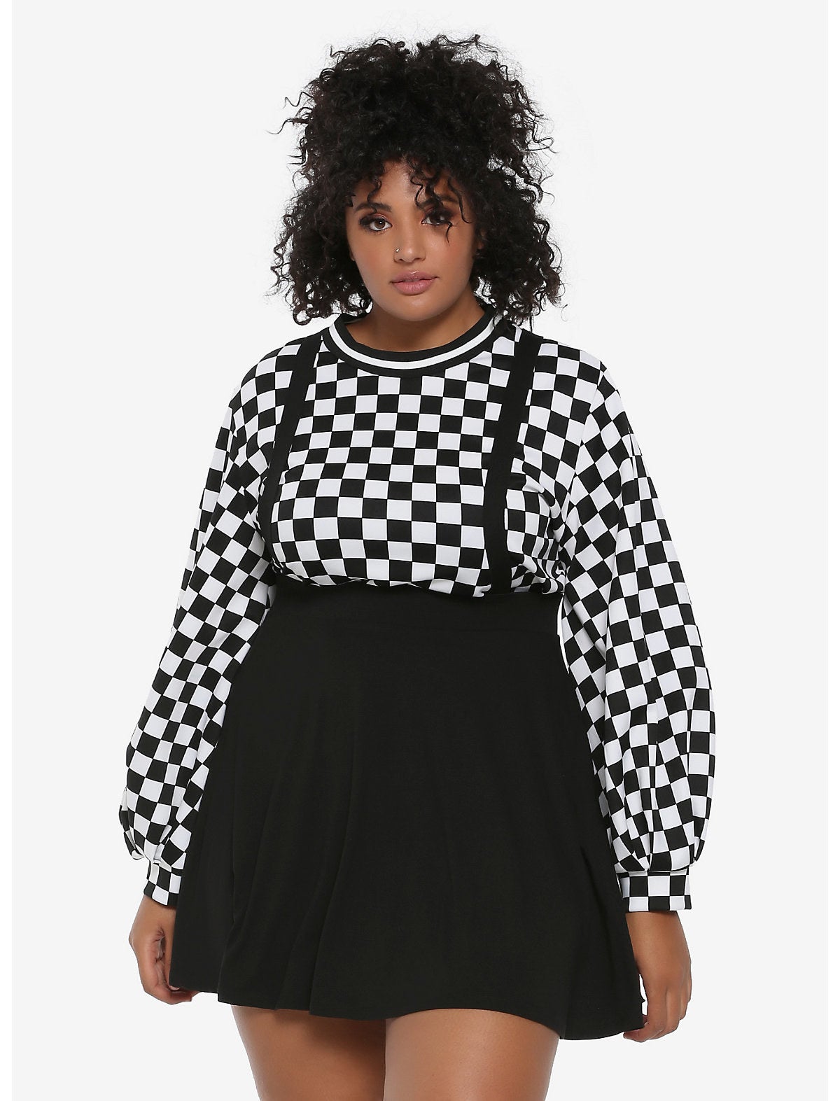 Model is wearing a black suspender circle skirt and a black and white checkered sweater underneath