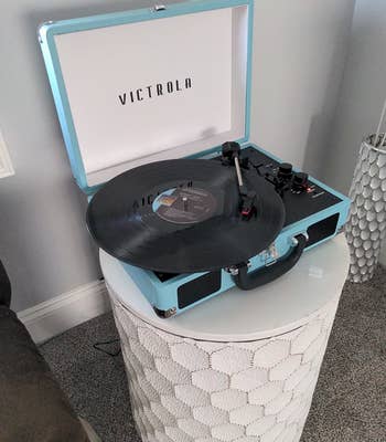 reviewer's turquoise record player