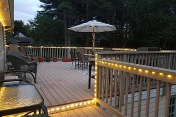 Reviewer image of deck with string lights strung around the perimeter