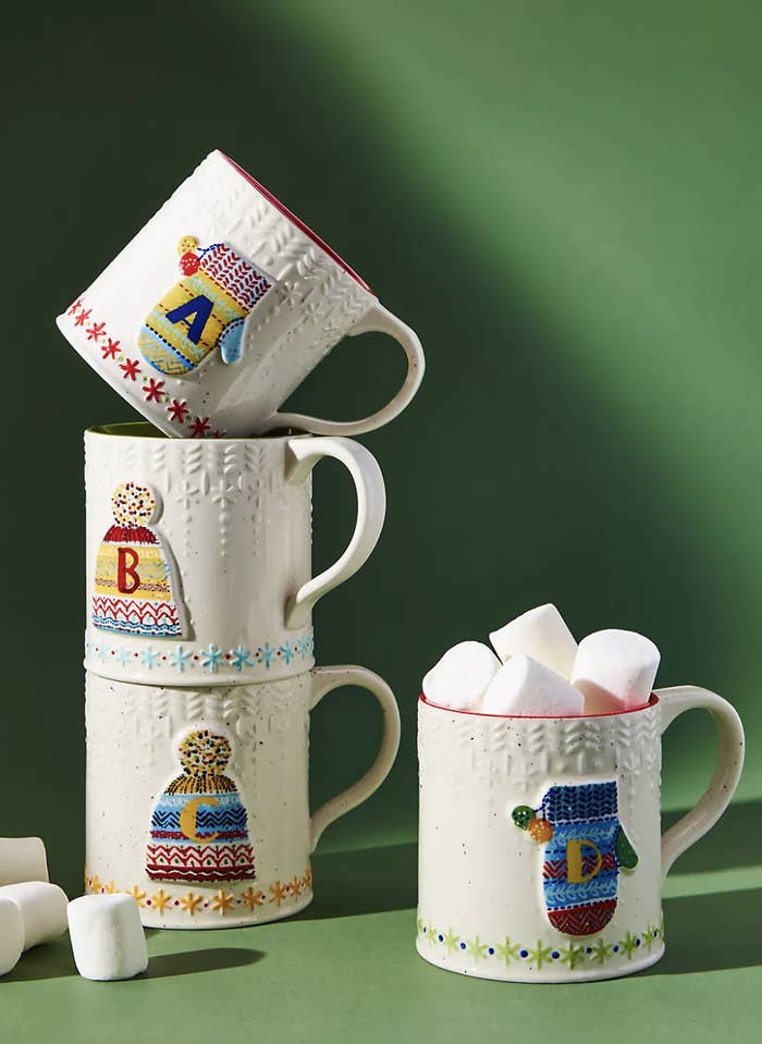 mugs with little hats and mittens with an initial in each one