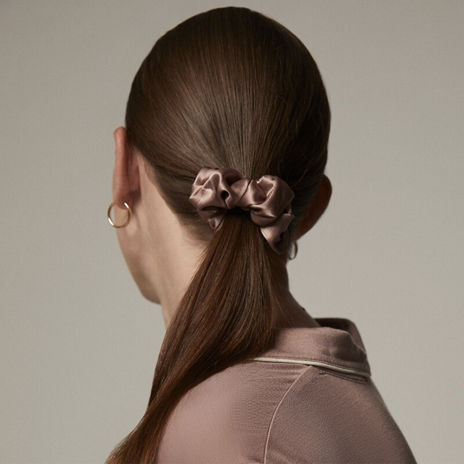A person wearing the scrunchie in their ponytail