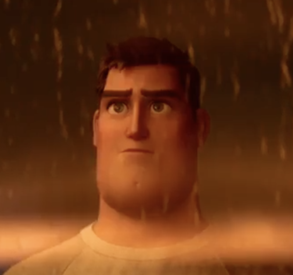 Photo of BUzz looking out of a window while it rains, he&#x27;s wearing a white t-shirt and hair is showing