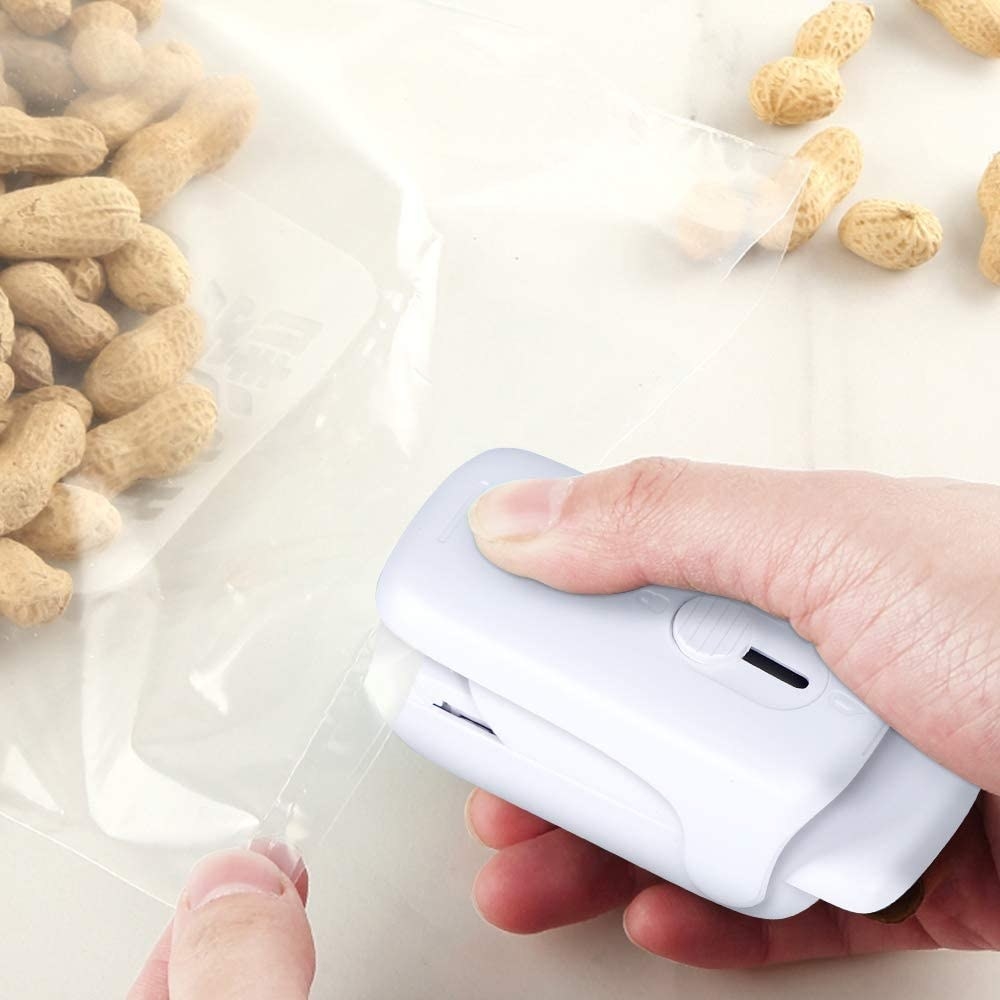 A person sealing a bag of peanuts with the bag sealer