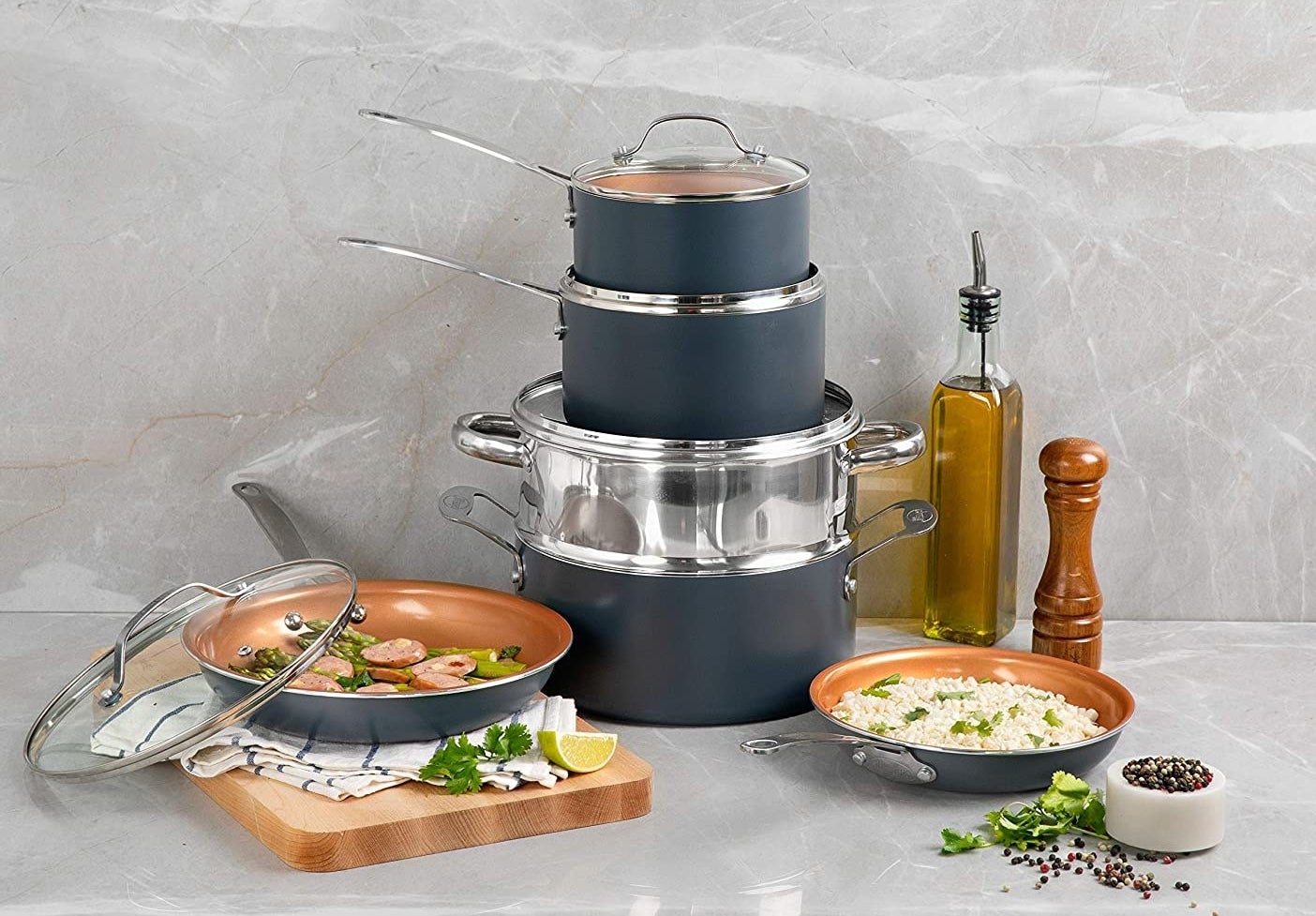 The aluminum cookware set in the color graphite, stacked together to show each piece