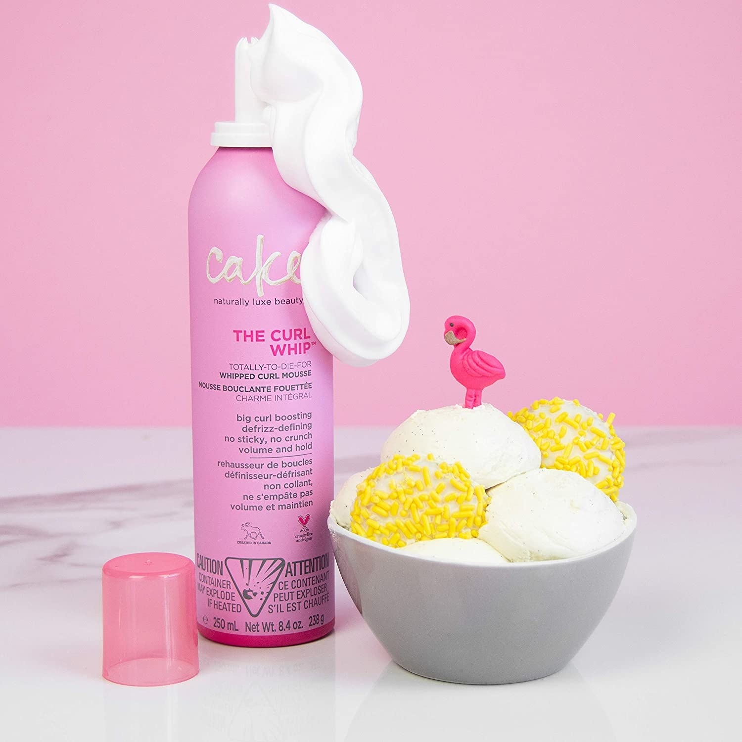 A can of hair mousse next to a bowl of ice cream