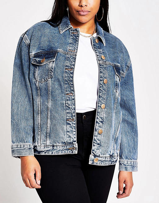a model wearing the medium wash jean jacket