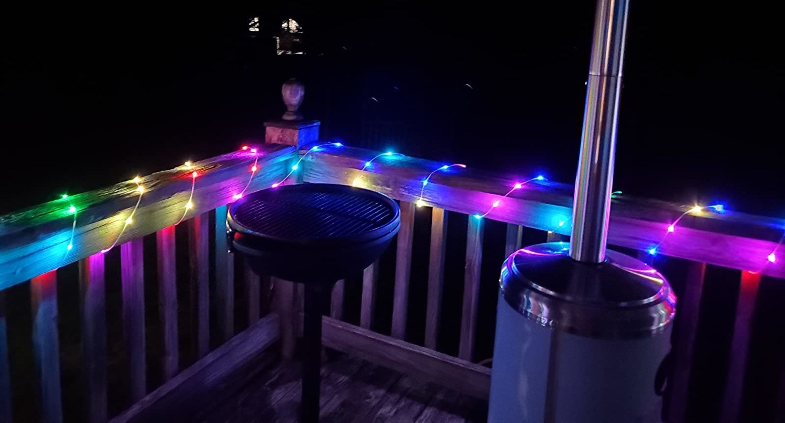 Reviewer image of rainbow colored lights wrapped around porch