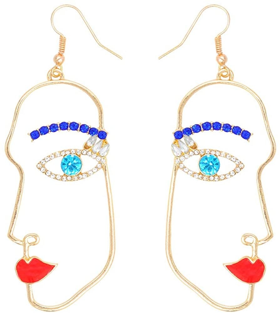 earrings shaped like abstract profile of a face with red lips and blue jeweled eyes and eybrows