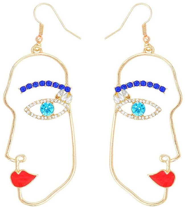 earrings shaped like abstract profile of a face with red lips and blue jeweled eyes and eybrows