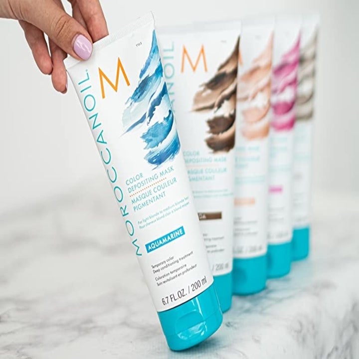 A row of bottles of hair color masks