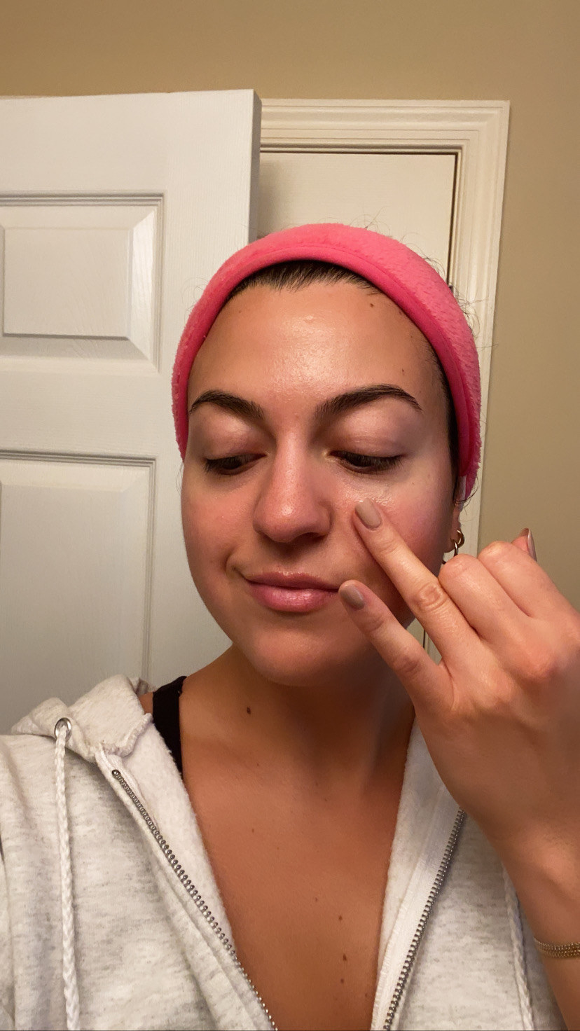 Me applying my beauty oil to my under eye area