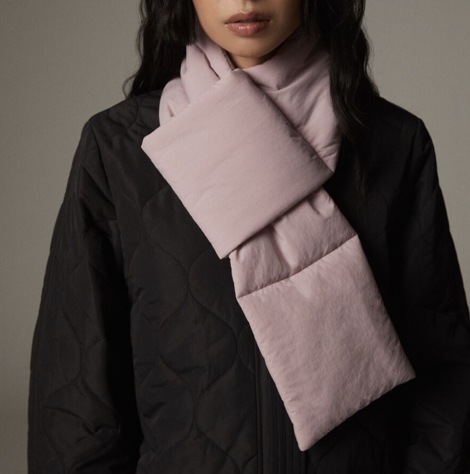 A person wearing the scarf with a puffer jacket