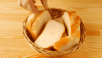 hand reaching into bread basket