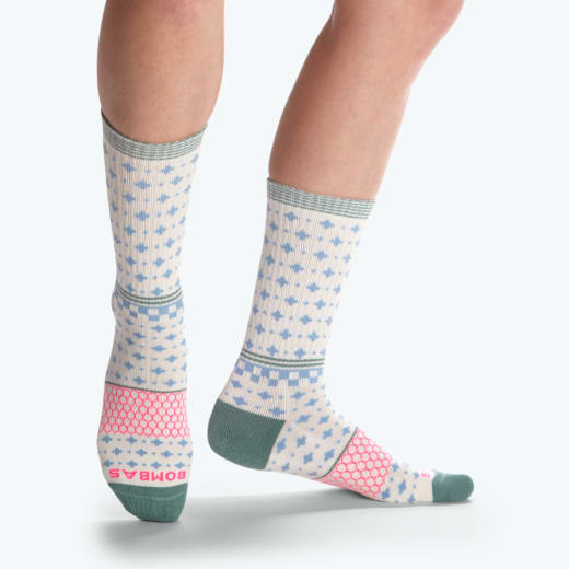 a model wearing the green, white, blue, and pink patterned socks