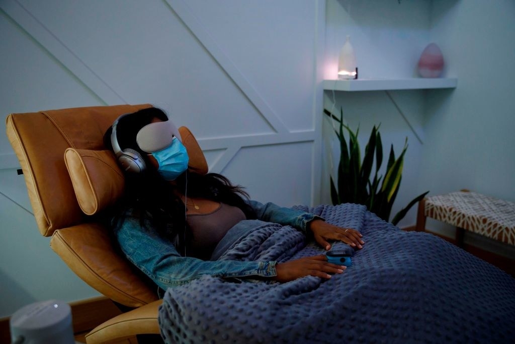 An image of a patient in a chair with headphones on getting ready for ketamine therapy