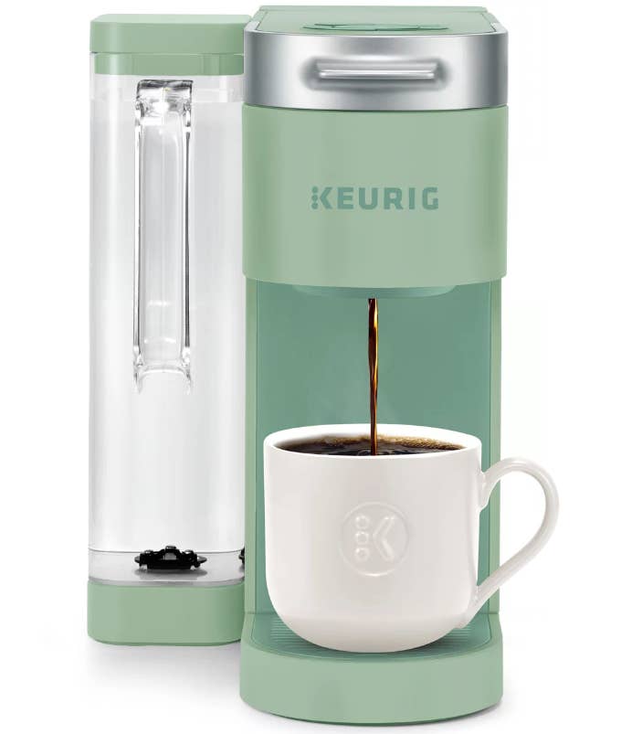 the k-supreme in mint green with a side water tank with a handle brewing a coffee