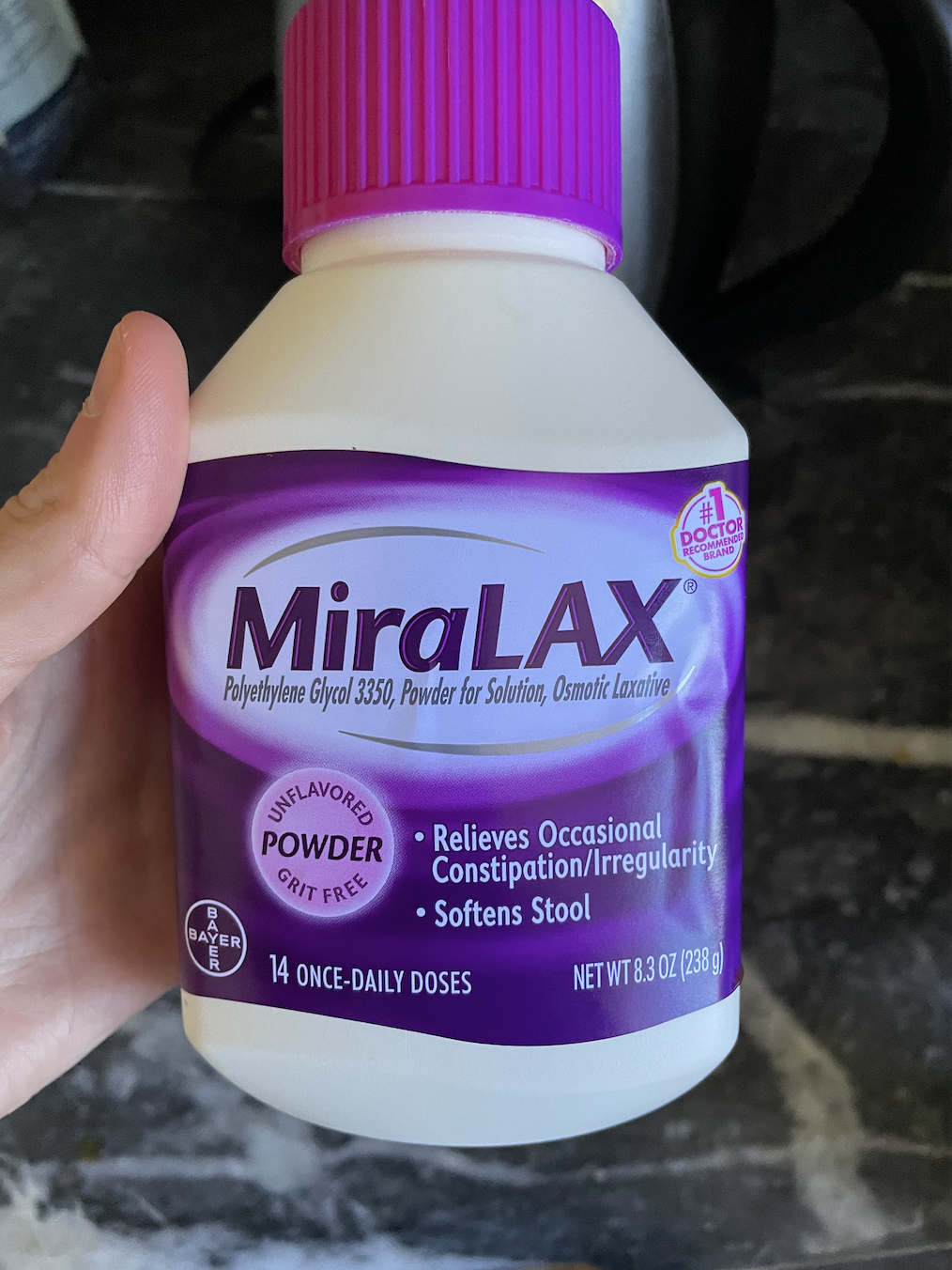 The author&#x27;s hand holding Miralax