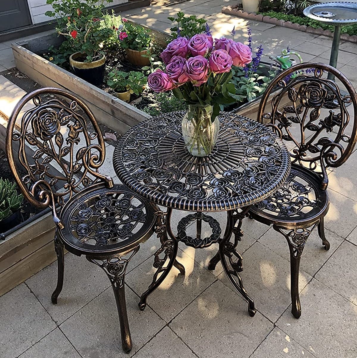 reviewer's bronze bistro dining set in their yard
