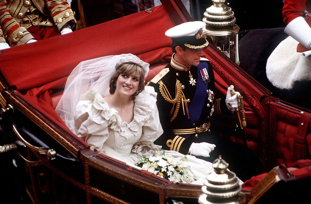 The Prince (R) and Princess of Wales return to Buckingham Palace by carriage after their wedding