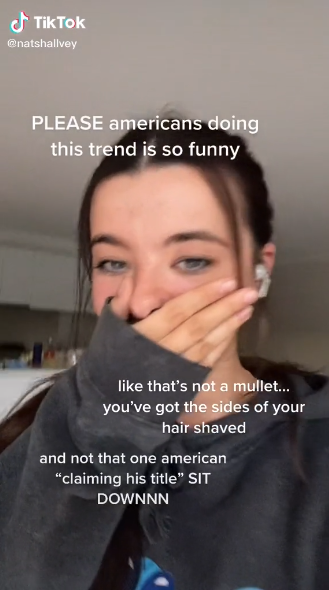 A girl covering her mouth trying not to laugh; there is next saying &quot;PLEASE Americans doing this trend is so funny...like that&#x27;s not a mullet, you&#x27;ve got the sides of your hair shaved&quot;