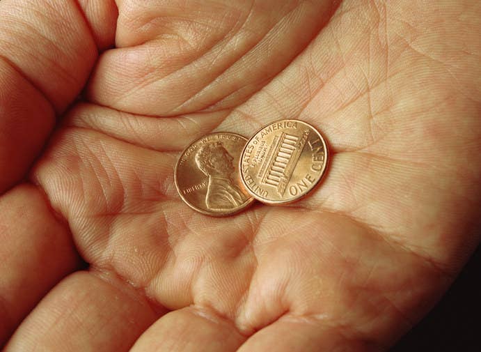 hand holding two pennies
